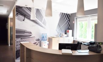 a modern office with a curved wooden reception desk and a large poster on the wall at Best East