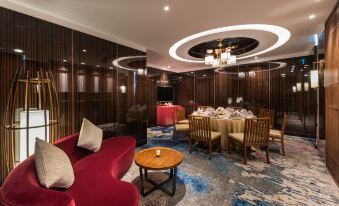 In the middle of the room, there are tables and chairs, adjacent to a dining area that is enclosed at Novotel Shanghai Hongqiao