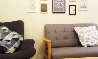a cozy living room with a couch and a chair , along with a picture on the wall at Leisure