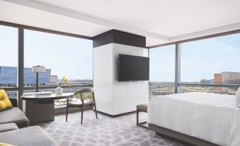 The bedroom features large windows, a bed, and a desk, with a view of other rooms at Cordis Shanghai Hongqiao