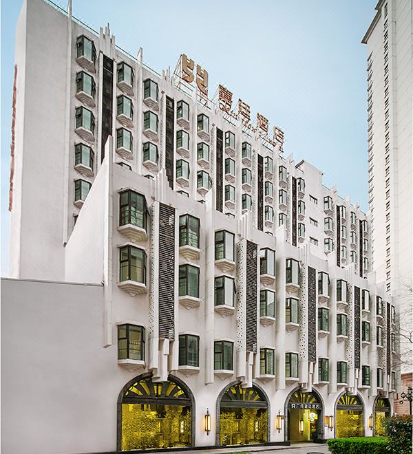 The exterior view of the building is modern and spacious, featuring an open frontage and a stone facade at Kingtown Hotel Plaza Shanghai
