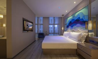 A modern bedroom with large windows, a bed, and a painting on the wall above it at Orange Hotel (Shanghai Pudong Airport)