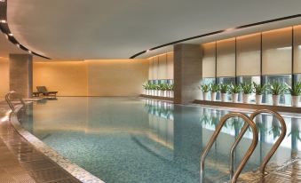 The hotel features an indoor pool with large windows and an infinity swimming area on the floor at Hyatt Place Shenzhen Airport