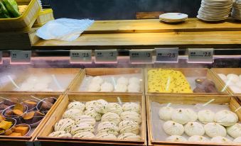 The bakery has a display case filled with various types of trays for sale at Motel Hotel (Shanghai Changping Road Metro Station)