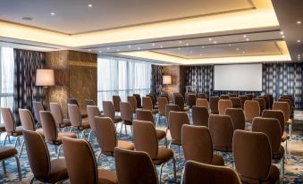 A spacious conference room is arranged with rows of chairs for events or conferences at Four Seasons Hotel Shenzhen