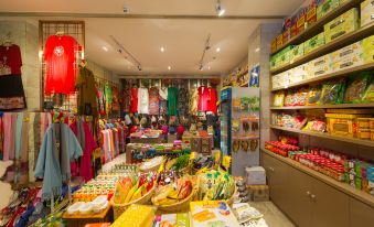 a store filled with a variety of items , including clothes , snacks , and other merchandise , arranged in neat rows at GuiLin ParkView Hotel