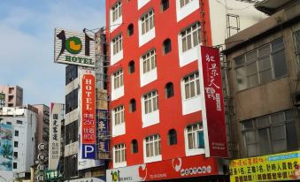 "a red and white building with a sign that reads "" 2 . 8 "" on the side of the building" at 101 Hotel