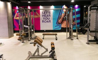 "a gym with a sign that says "" let 's hear you roar "" and some exercise equipment" at Palm Seremban Hotel