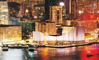 A city's illuminated skyline at night, with buildings on both sides at The Salisbury YMCA of Hong Kong