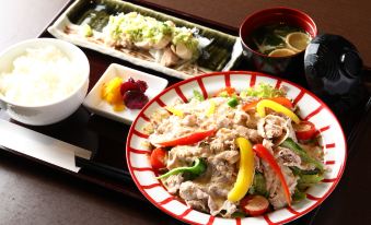 a dining table with a variety of food items , including fish , vegetables , and a bowl of soup at Hotel Wing International Himeji