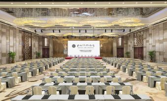 A spacious event room is arranged with tables and chairs in the center at Pullman Guangzhou Baiyun Airport