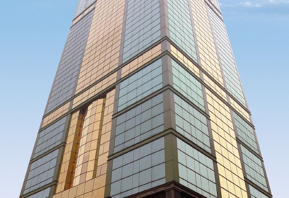 In front of an office tower, there is a tall building with numerous windows on its side at Best Western Plus Hotel Hong Kong