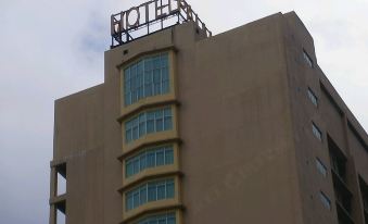 "a tall building with a "" hotel "" sign on top of it , surrounded by other buildings" at Palm Seremban Hotel