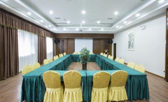 a conference room set up for a meeting , with chairs arranged in a semicircle around a long table at Panda Hotel