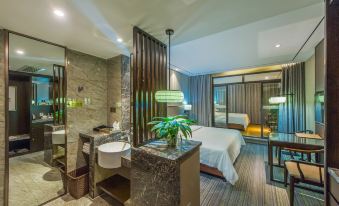 a modern hotel room with a marble bathroom , sink , and bed , as well as a bed in the background at GuiLin ParkView Hotel