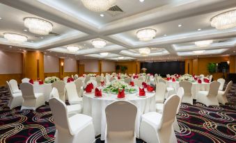 a ballroom with tables and chairs arranged for an event at Park Inn by Radisson Shanghai Downtown