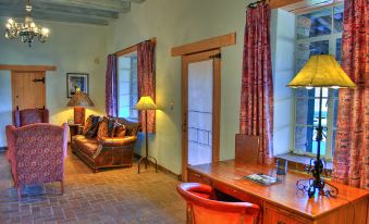 a cozy living room with a couch , a dining table , and a fireplace in the background at Tubac Golf Resort & Spa