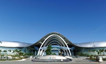 a large building with a modern design , possibly a train station or a train station at Sanya Haitang Bay Island Villa (International Duty Free City Branch)