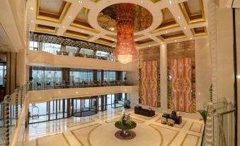 The large building features a lobby with marble floors and chandeliers on each side, along with an impressive ceiling at Bai Fu Yi Hotel