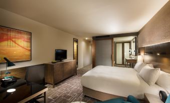 a hotel room with a king - sized bed , a flat - screen tv , and a bathroom with a shower at Pan Pacific Melbourne