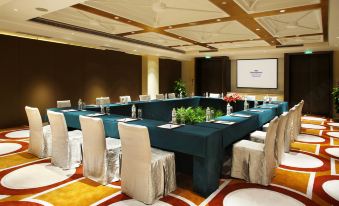 A spacious room is arranged with long tables and chairs for events or functions at Howard Johnson Sunshine Plaza Ningbo