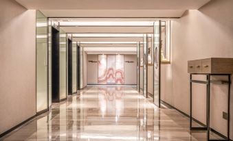 In the main room of this modern home, there is a long hallway with tiled floors and walls at Hotel Landmark Canton Guangzhou