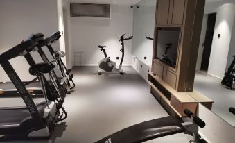The room is equipped with a large treadmill, exercise equipment, and an indoor area at Citadines Apart Hotel (Shanghai Yan'an West Road)
