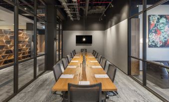 a long wooden conference table with chairs and papers , set up in an office conference room at Sage Melbourne Ringwood