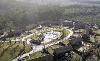aerial view of a village surrounded by trees , with a large circular fountain in the center at Alba Wellness Resort by Fusion