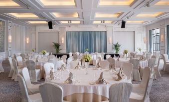 A ballroom is arranged for an event, with tables and chairs placed in the center at Marco Polo Xiamen