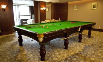 A spacious game area in the hotel with pool tables and other amenities for guests to enjoy at Hotel Fortuna