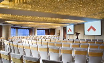 A spacious conference room with rows of chairs in the center for events or conferences at Swissotel Foshan Guangdong