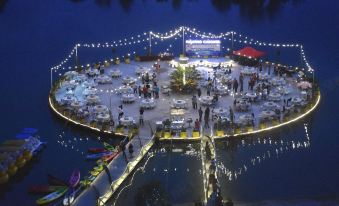 a nighttime scene of a large , circular banquet hall with tables and chairs set up for an event at Marina Island Pangkor Resort & Hotel
