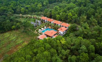 a bird 's eye view of a large house surrounded by trees and a pool in the middle of it at Bai Dinh Garden Resort & Spa