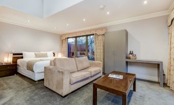 a modern living room with a couch , coffee table , and sliding glass doors leading to an outdoor area at Seymours on Lydiard