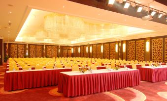 A spacious room is set up with rows of long tables for an event or function at Ocean Hotel