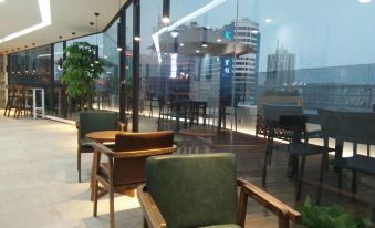 elegant restaurant with spacious windows that offer a picturesque view of the surroundings at Moka Apartment (Guangzhou CUHK Cancer Hospital Taojin Subway Station)