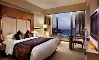 A bedroom with large windows and a balcony that overlooks the city, featuring a bed positioned in front at Sofitel Macau at Sofitel Macau at Ponte 16