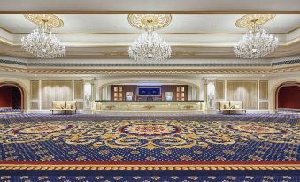 The large, ornate room in the middle features carpet and chandeliers at The Parisian Macao
