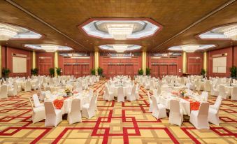 There is a spacious ballroom in the hotel, arranged with tables and chairs for an event at The Great Wall Hotel Beijing