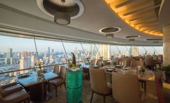 The restaurant on the upper deck offers a panoramic view of the city through its large windows and floor-to-ceiling glass at Radisson Blu Hotel Shanghai New World