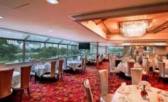 The restaurant features spacious dining rooms with large windows and tables that can accommodate up to 10 people at Regal Riverside Hotel