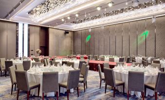 A spacious room is arranged with tables and chairs for hosting events or formal dining at Amara Signature Shanghai