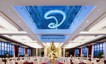 The ballroom is decorated with tables and chairs arranged for an event at YiWu Zhonglian Kaixin Hotel