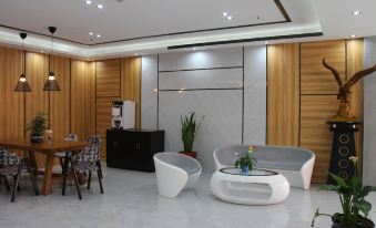A lobby with large windows, chairs, and tables in the center serves as an office space at Super 8 Hotel (Shanghai Pudong Airport Chenyang Road)