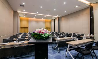 There is a spacious conference room arranged with long tables and chairs for events or meetings at Sky Bird Hotel (Shanghai Hongqiao Airport)