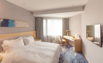 The modern-style bedroom features a double bed and a large window that overlooks the rest area at City Hotel