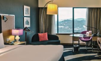 There is a bedroom with large windows and an attached bathroom, with another room alongside it at Wyndham Grand Bangsar Kuala Lumpur(Formerly Pullman Kuala Lumpur Bangsar)