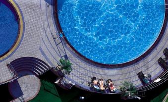 an aerial view of a crowded swimming pool at JinLing Purple Mountain Hotel Shanghai