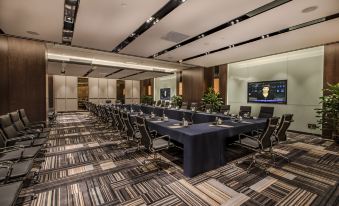 There is a spacious conference room arranged with long tables and chairs for hosting events or meetings at Orchid Sea Hotel